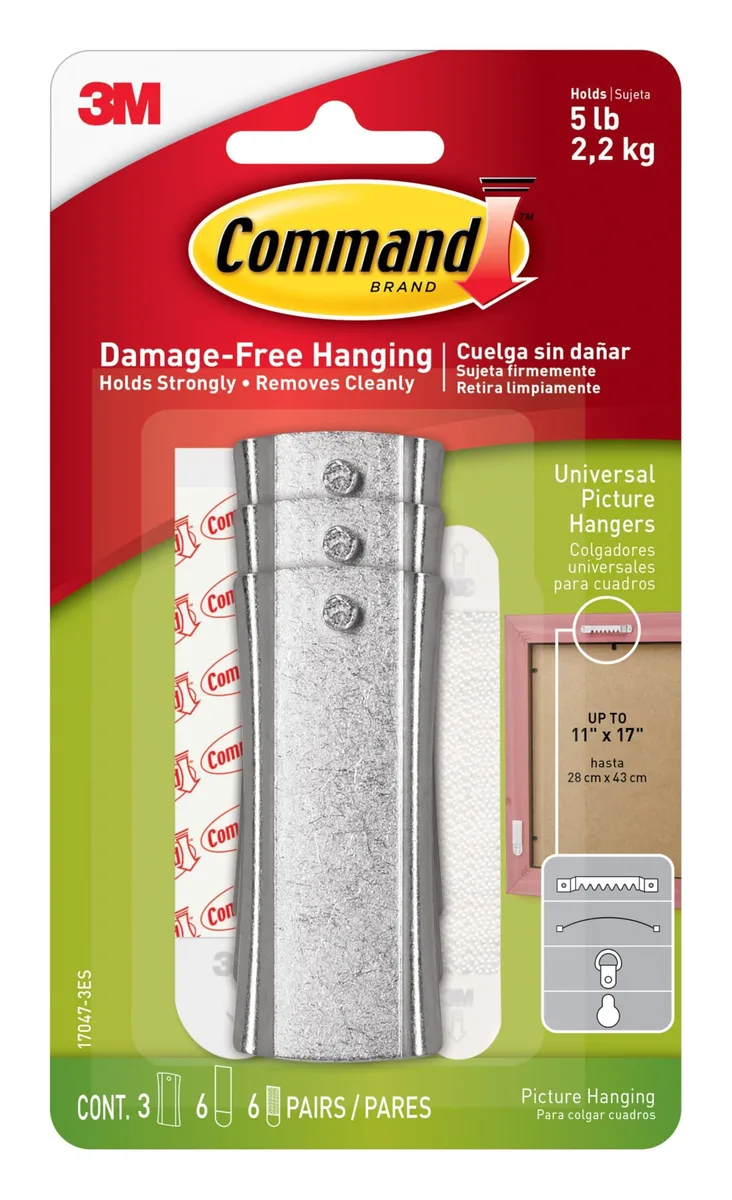 Three metallic-gray hangers with white adhesive strips and clear stabilizers on a backing card
