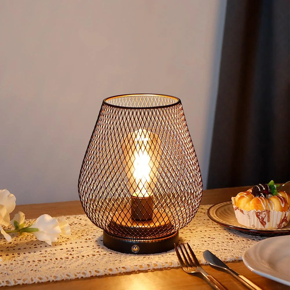 Lantern-style cordless table lamp with metal cage and warm LED glow