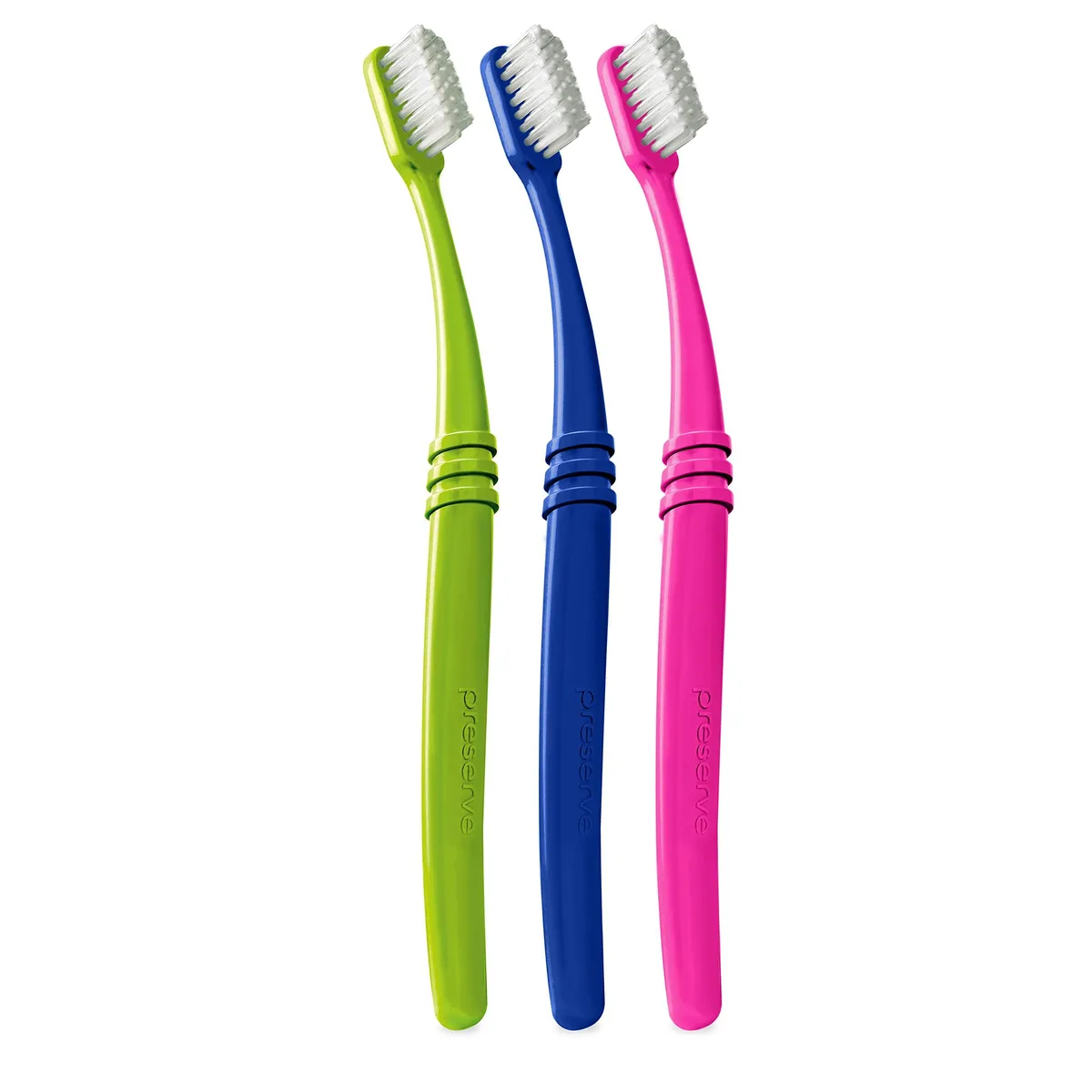 Three white manual toothbrushes with curved handles and soft tiered bristles in lightweight paper packaging