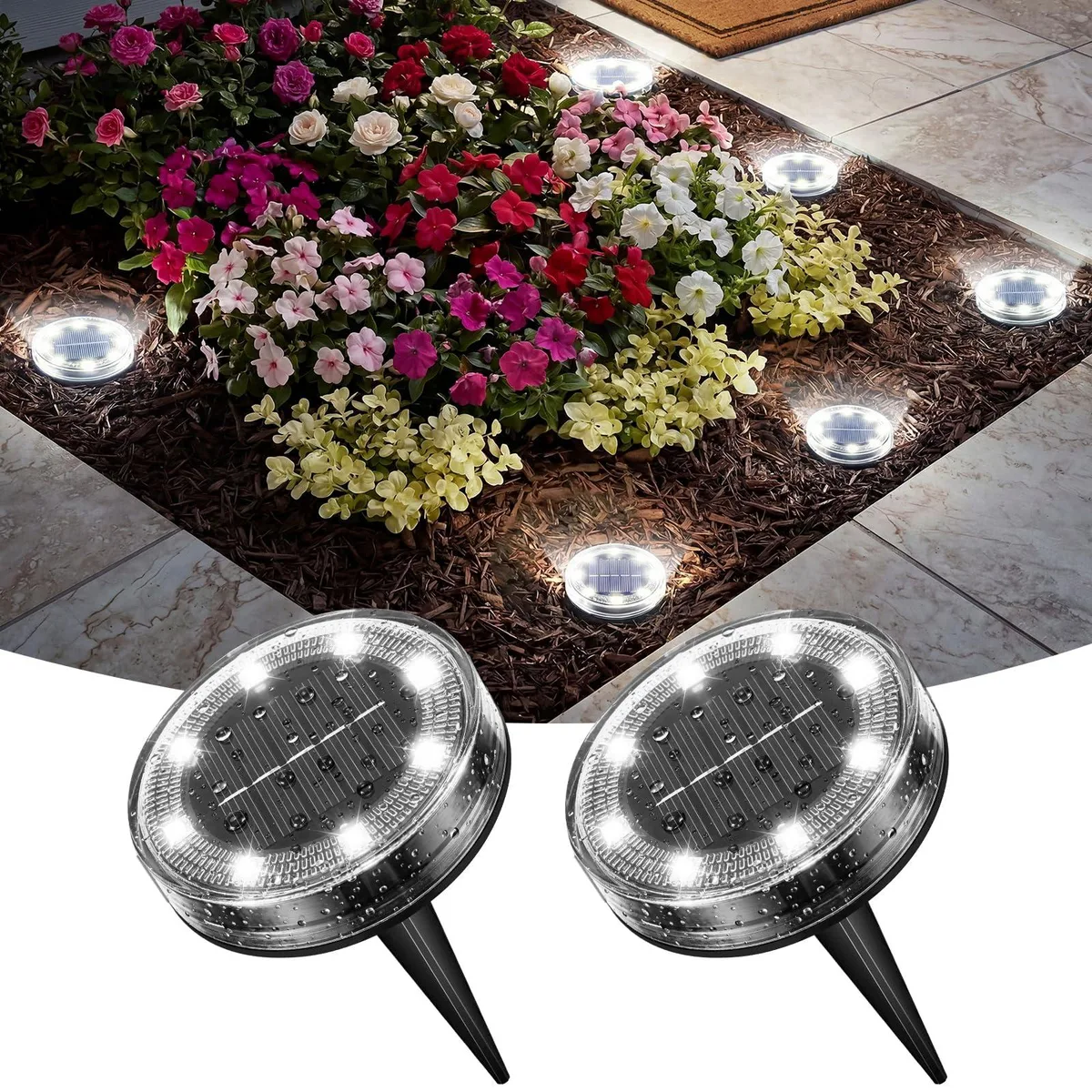 Two small round ABS solar ground lights, cold white finish, stake mounted