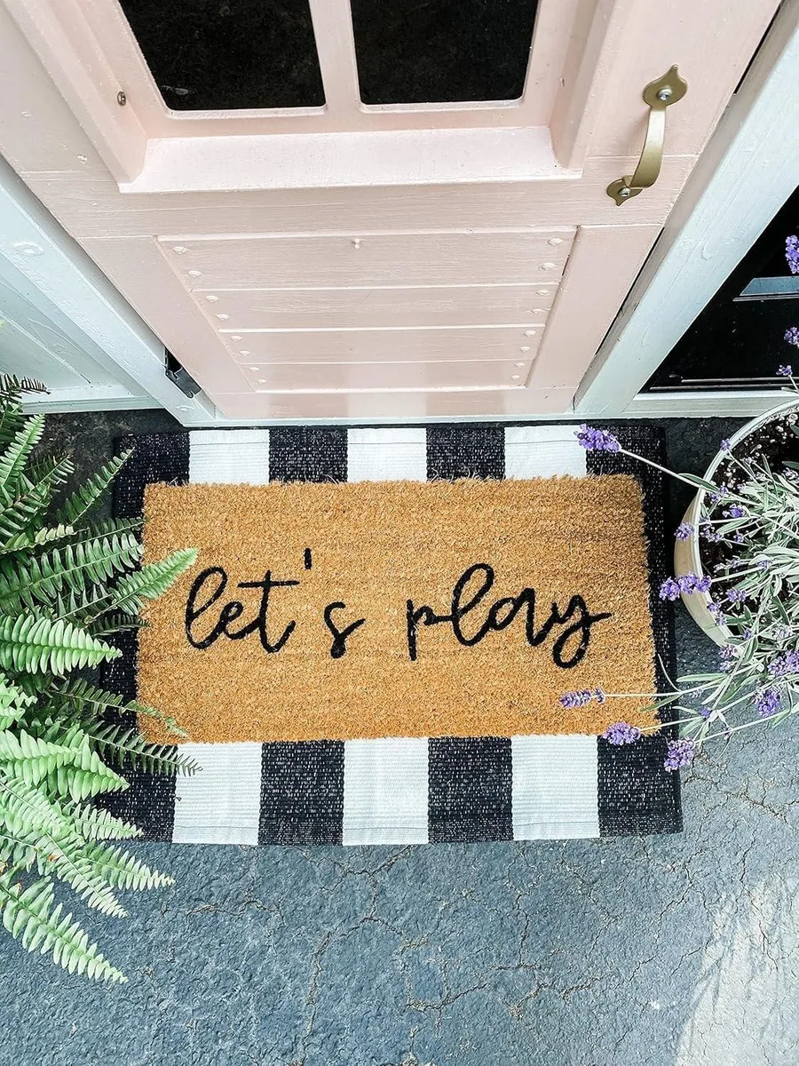 Black polyester doormat, 16 by 24 inches, machine-made with non-slip dotted backing