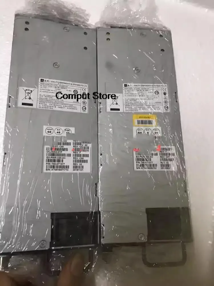 Rectangular silver metal power supply unit with ventilation grilles and rear connector panel