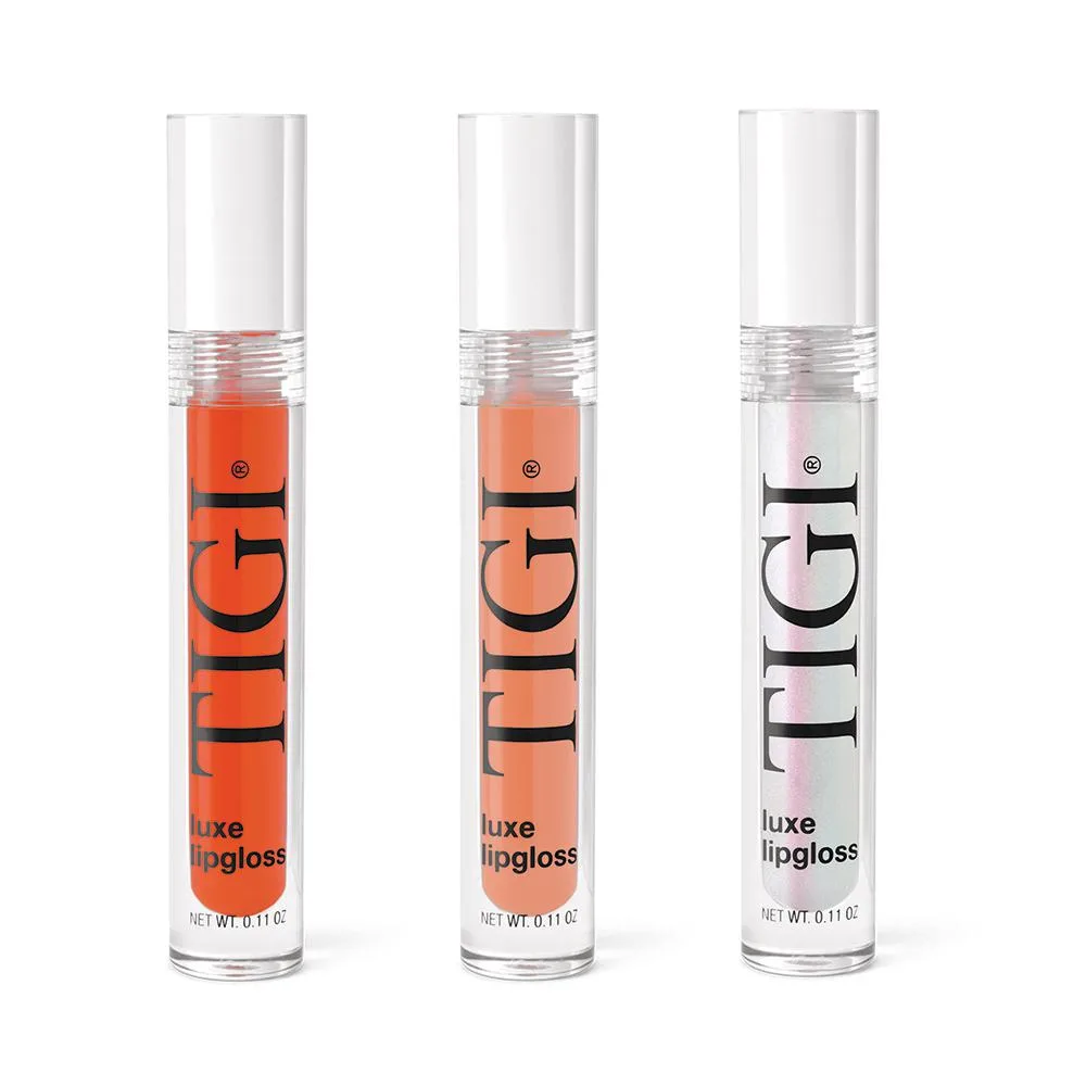 Three glossy lip gloss tubes in a row, silver caps, pastel liquids visible