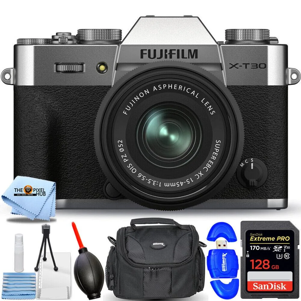 Silver mirrorless camera with compact zoom lens, gadget bag and accessories