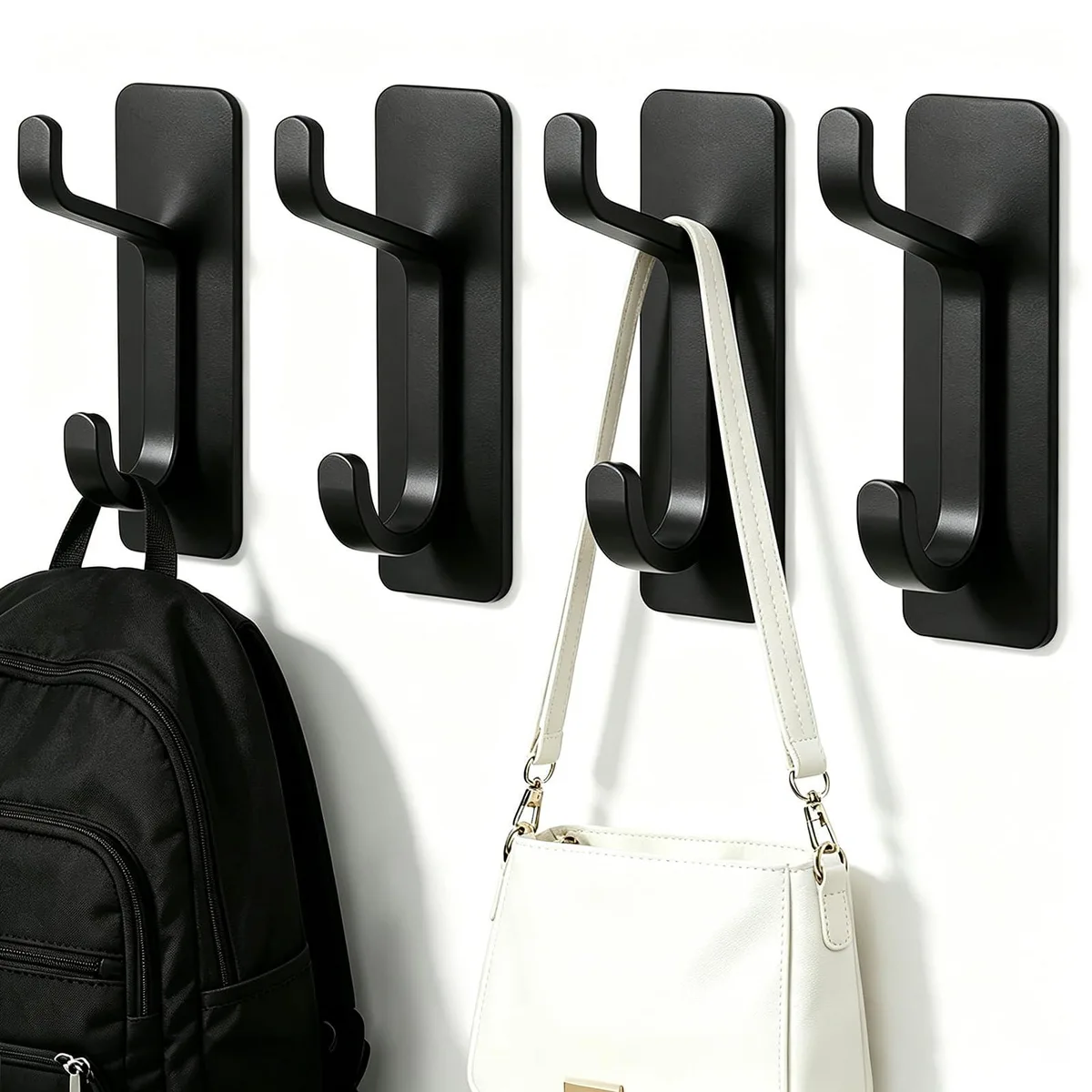 Four black stainless steel double hooks with adhesive pads