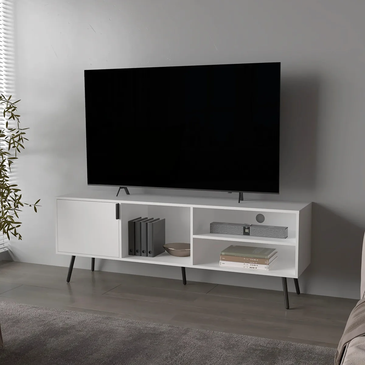 White particle-board TV stand with four shelves, one door and open storage