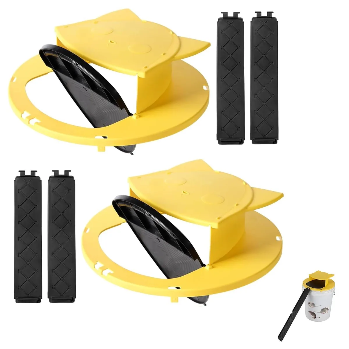 Two black plastic trap lids with flip doors sitting on orange five-gallon buckets