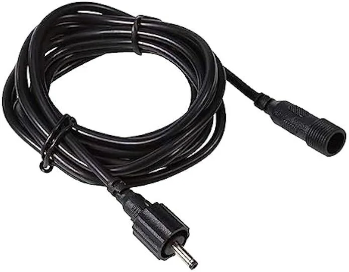 Two green waterproof extension cords with barrel connectors coiled on white background