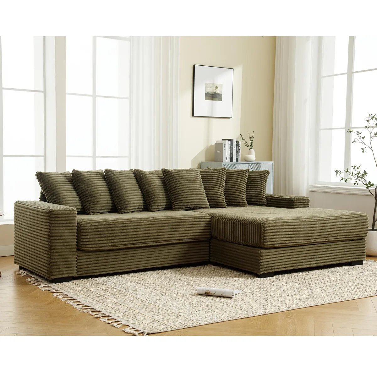 Green corduroy L-shaped sectional with right chaise, armrests and eight matching pillows