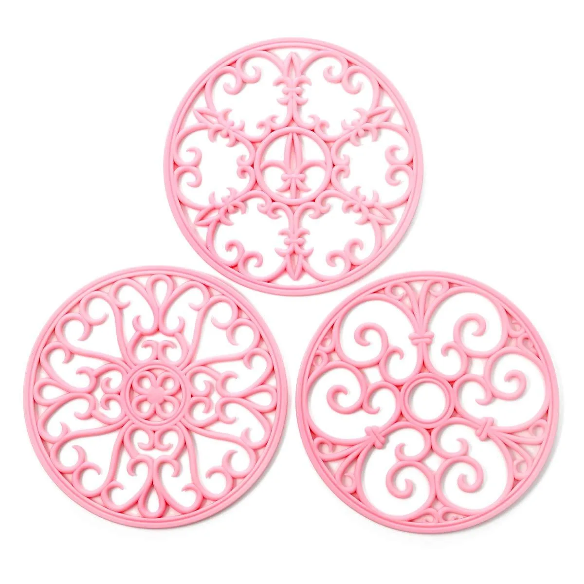 Three pink silicone trivet mats with different textured patterns