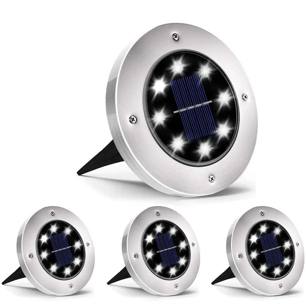 Four white solar stake lights with clear prismatic tops on stainless steel bodies