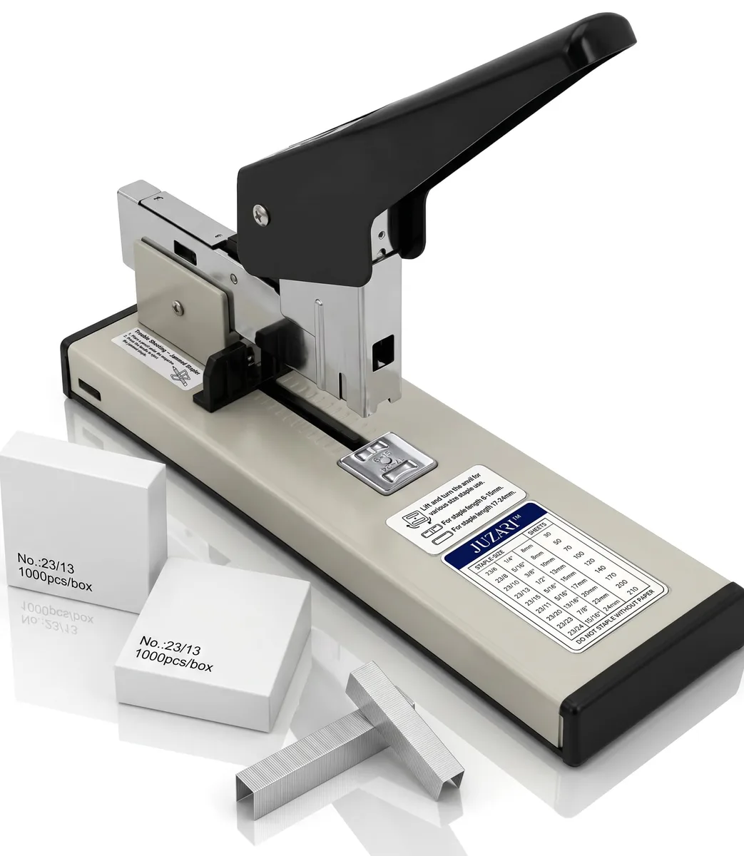 A metal desktop stapler with a long lever arm, adjustable paper guide and non-slip base, shown with a box of staples