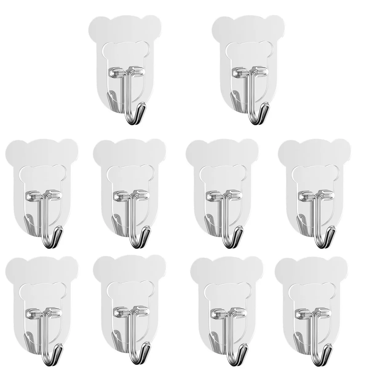 Ten small transparent bear-shaped adhesive hooks on a white surface