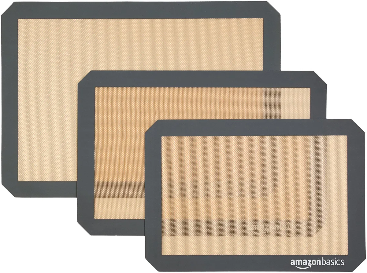Three rectangular beige-grey silicone baking mats stacked flat