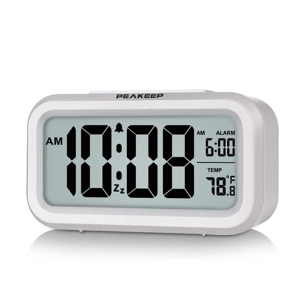 White rectangular digital alarm clock with LCD display, night light and indoor temperature readout
