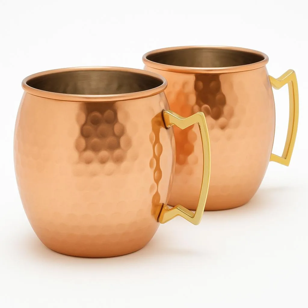 Two handmade hammered copper mugs with nickel lining and brass handles