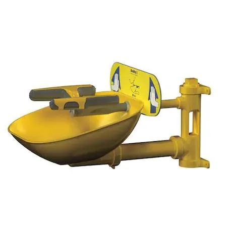 Wall-mounted plumbed eyewash station, yellow plastic bowl, galvanised steel piping, push-plate activation