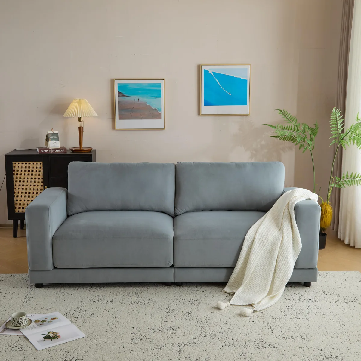 Gray velvet sofa with square arms and sturdy legs