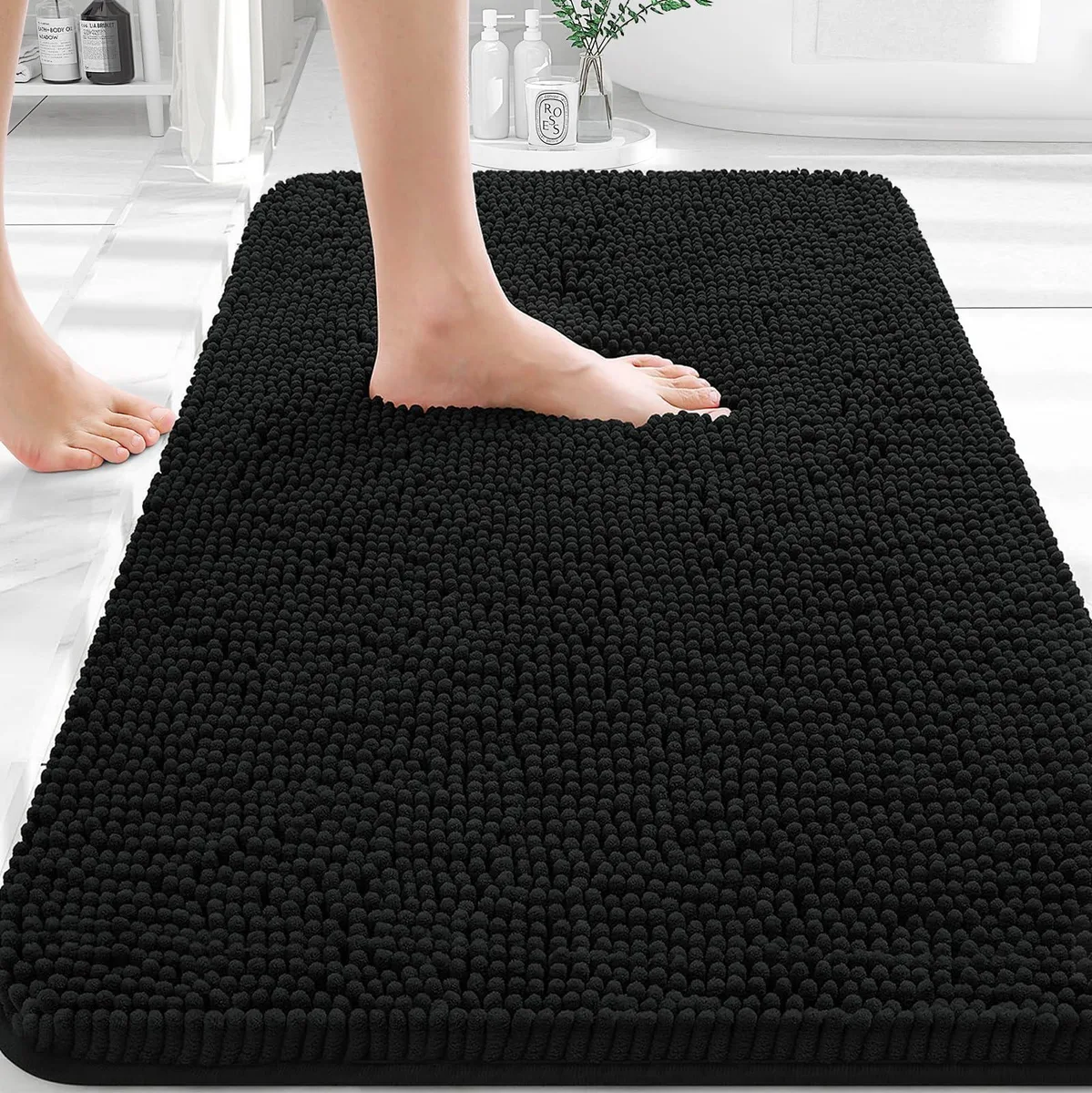 Rectangular beige chenille bath mat with rubber backing, 30 by 20 inches