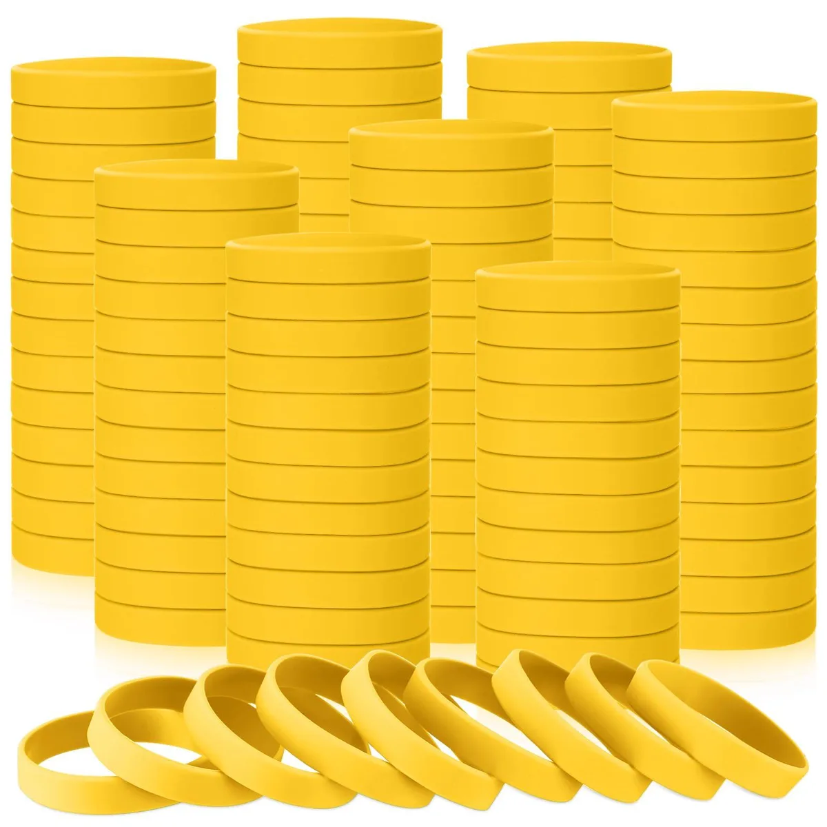 A pile of 50 yellow silicone wristbands, flat and flexible, plain rubber finish