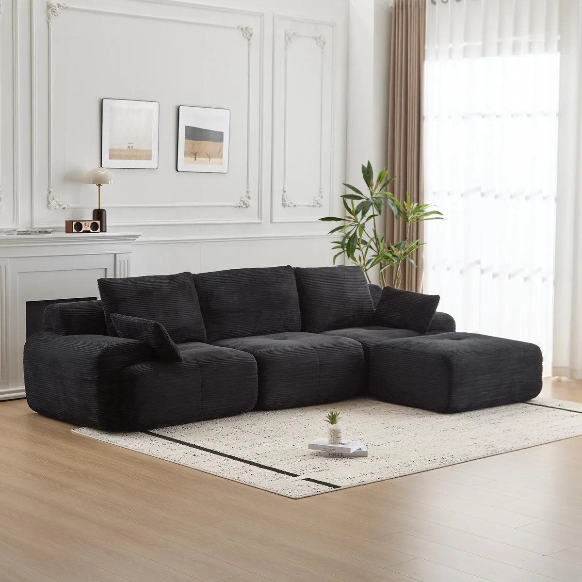 Black corduroy sectional sofa with deep cushions and scatter pillows
