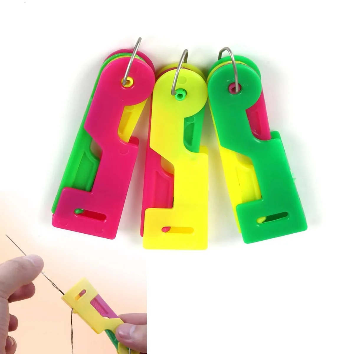 Three small metal needle threaders with coloured loops, each about 2.75 inches long