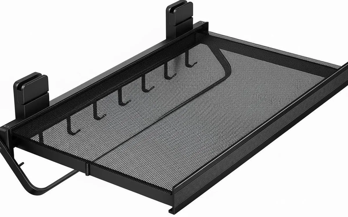 Wall-mounted retractable drying rack with mesh panel and hooks, folded flat against white wall