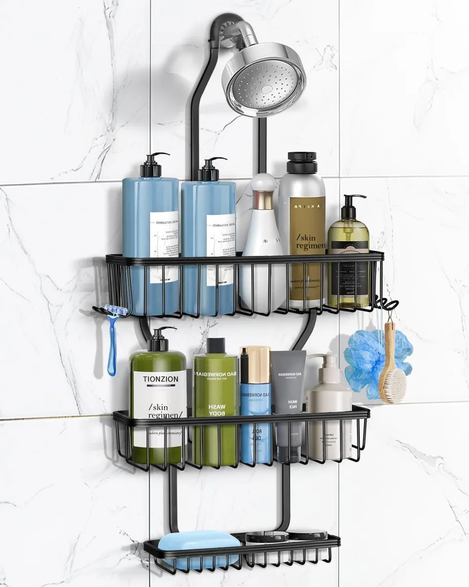 Black aluminum shower caddy with three tiered baskets and six hooks hanging over showerhead