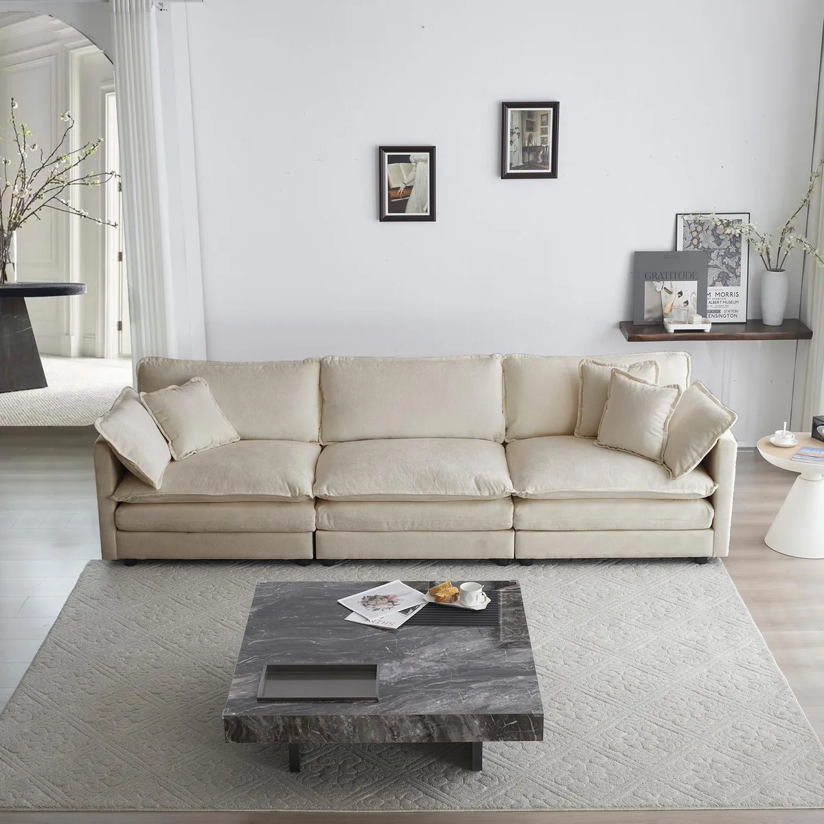 Beige chenille three-seater sofa with five pillows
