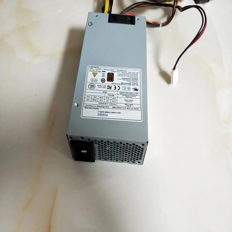Compact silver 1U power supply unit with rear fan grille and side label