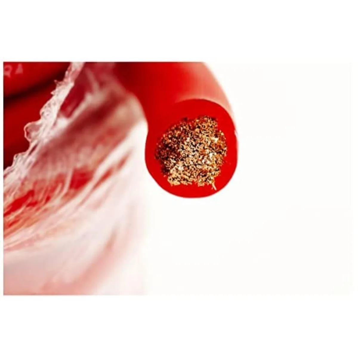 Red copper cable coiled on a light surface