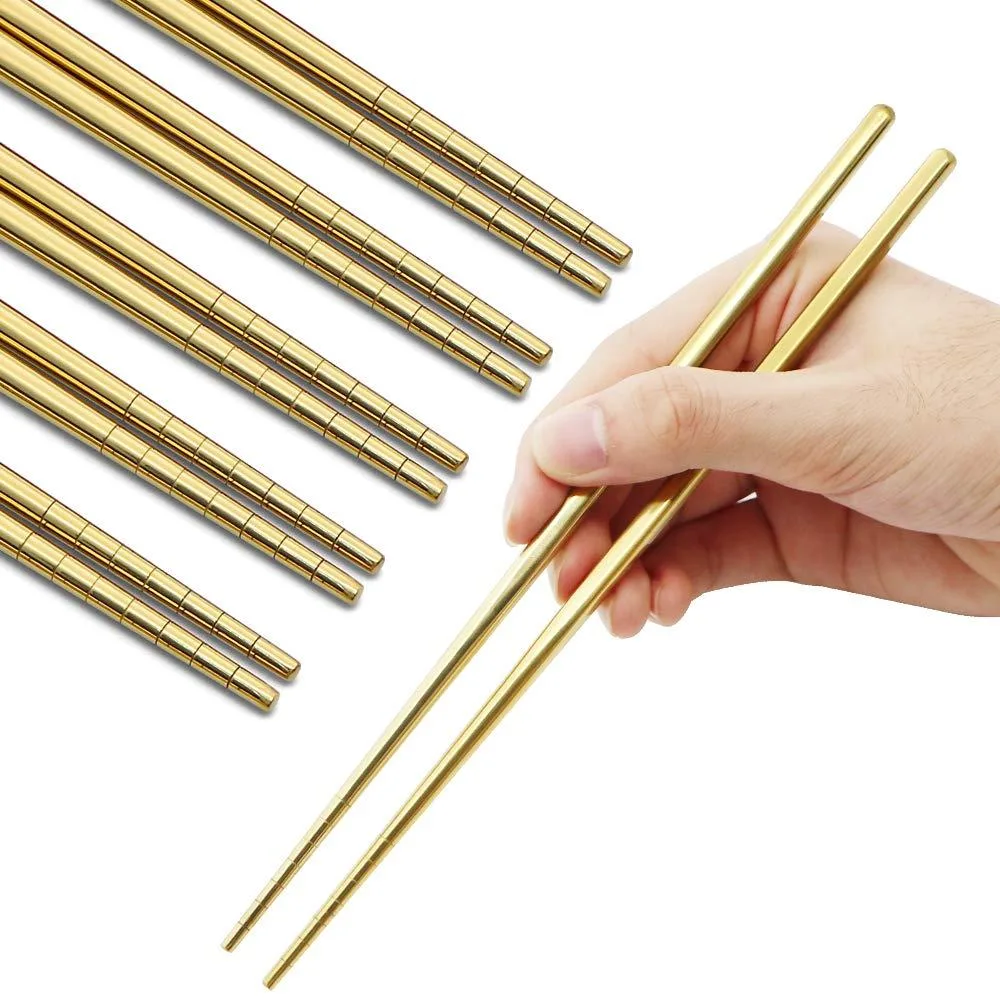 Five pairs of gold stainless steel chopsticks with floral handles and grooved tips