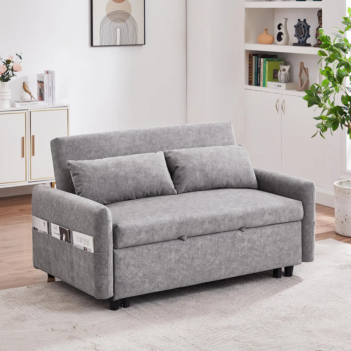 Grey microfiber pull-out sofa bed with two pillows and side pockets