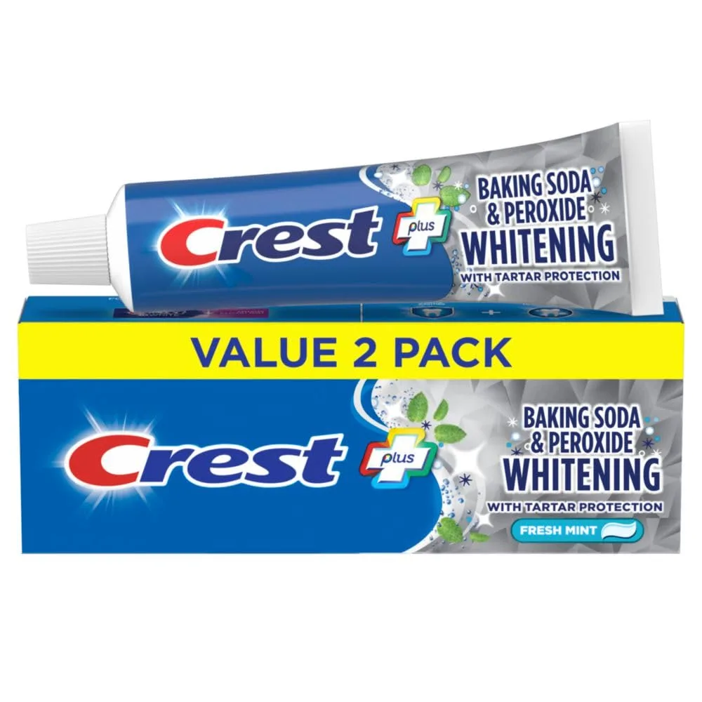 Two white 5.7 oz toothpaste tubes with blue caps on a plain background