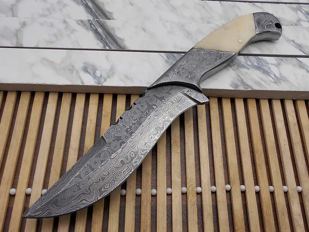 10.5 inch skinning knife with 5.5 inch Damascus blade, white camel bone handle, leather sheath