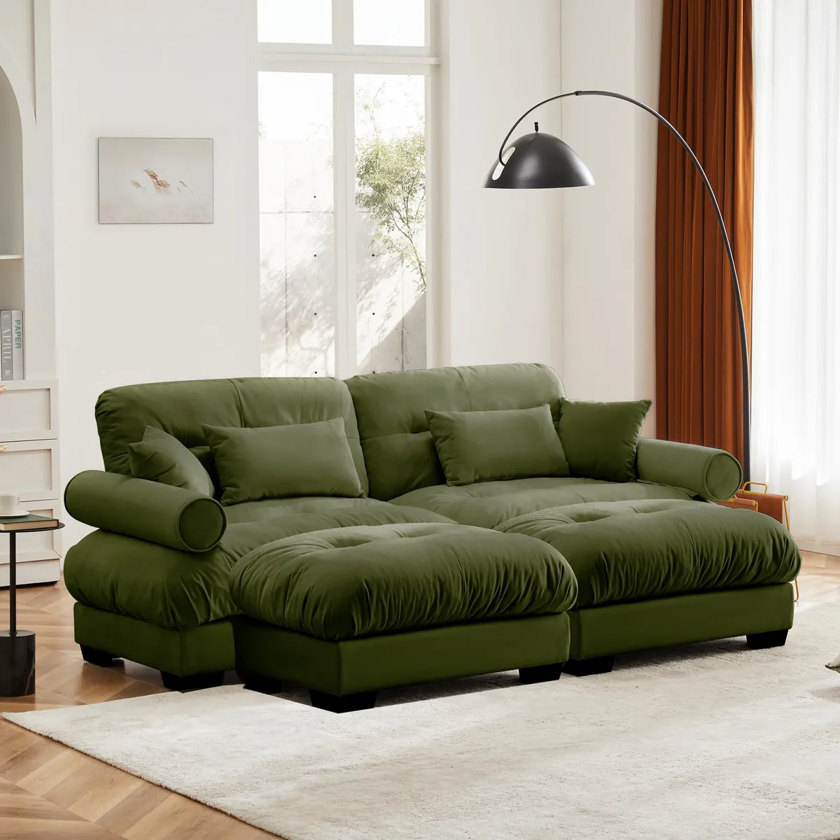 Olive green velvet two-seater sofa with matching ottoman, round bolster armrests, waist and throw pillows