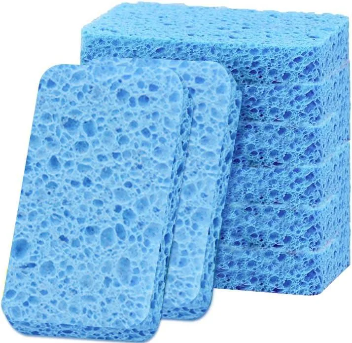 Six compressed blue cellulose sponges on a card, thin dry sheets that swell when wet