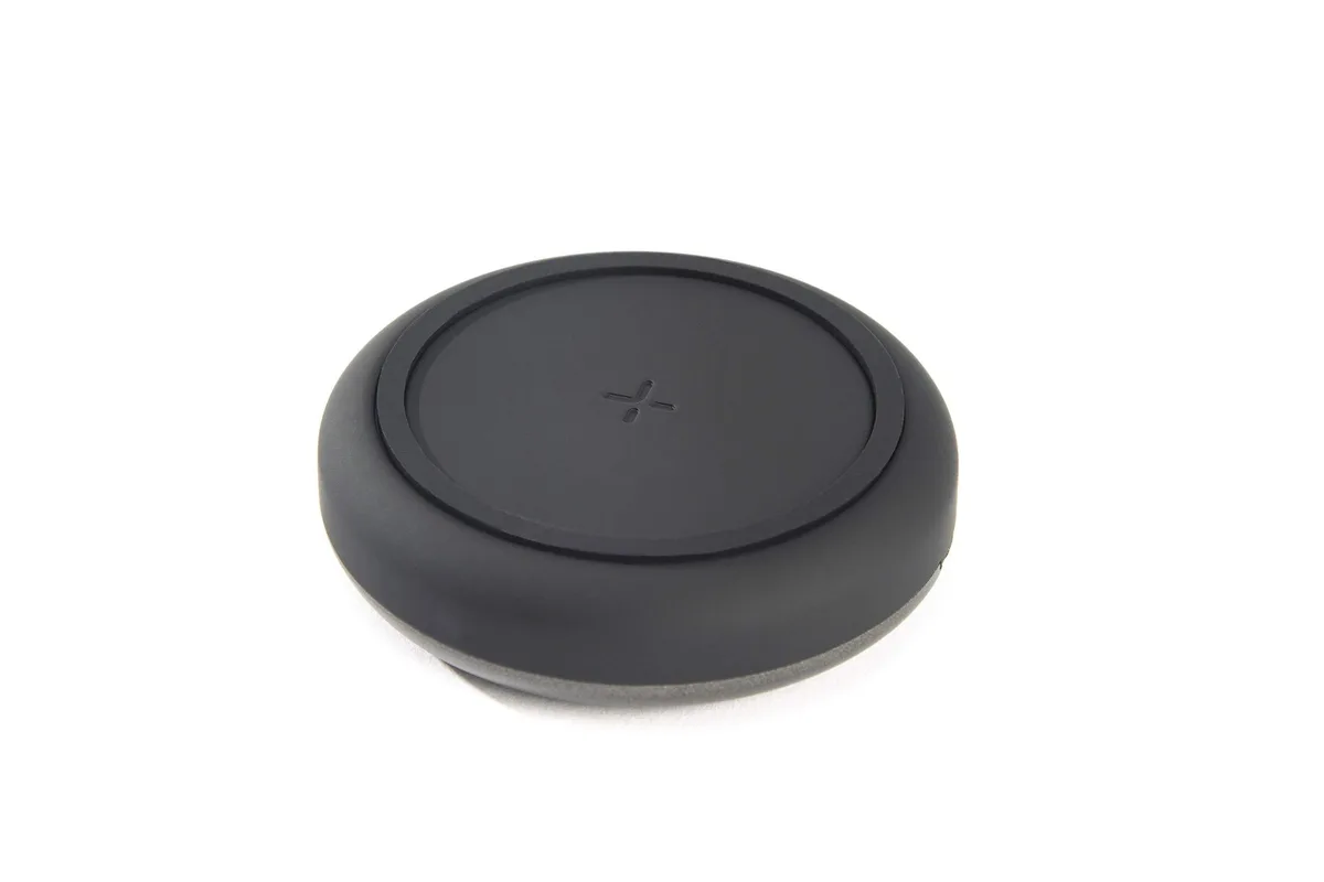 A round wireless charging pad with a soft-touch finish and a 3.3ft USB-C cable attached