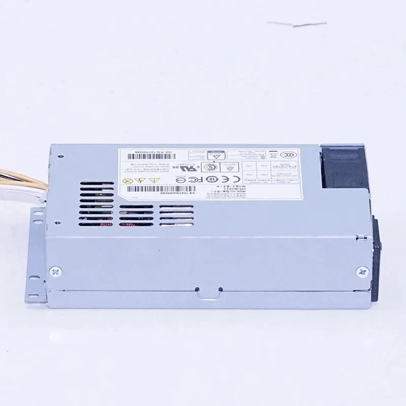 Silver rectangular ATX power supply unit with cooling fan grille and cable bundle