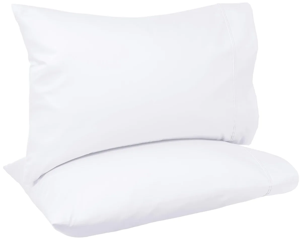Two white cotton pillowcases folded flat on a surface