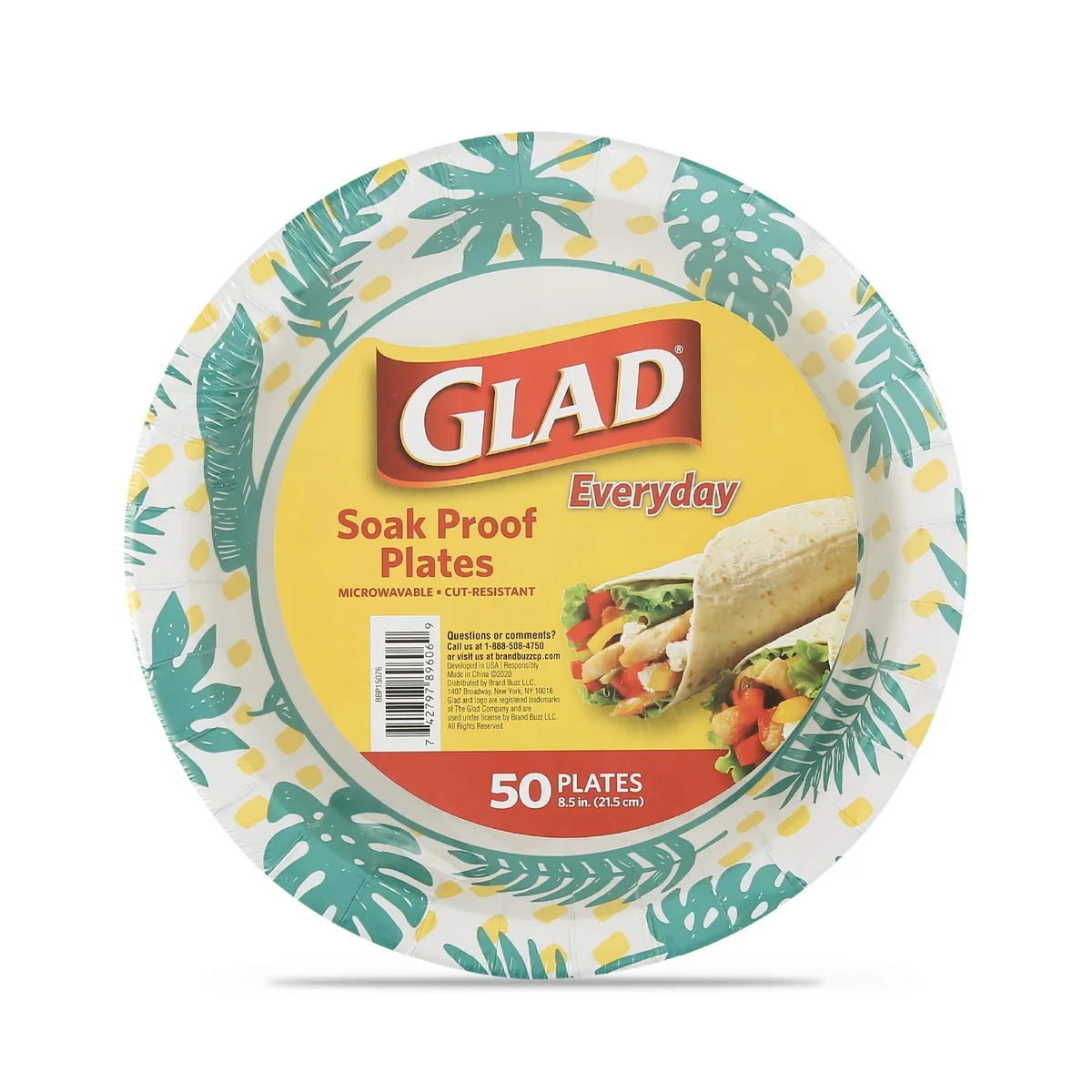 Stack of white rectangular disposable plates with green palm leaf pattern on the rim