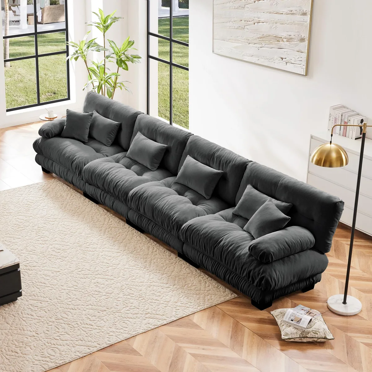 Modular four-seat sectional in gray chenille fabric with rounded bolster armrests and deep cushions