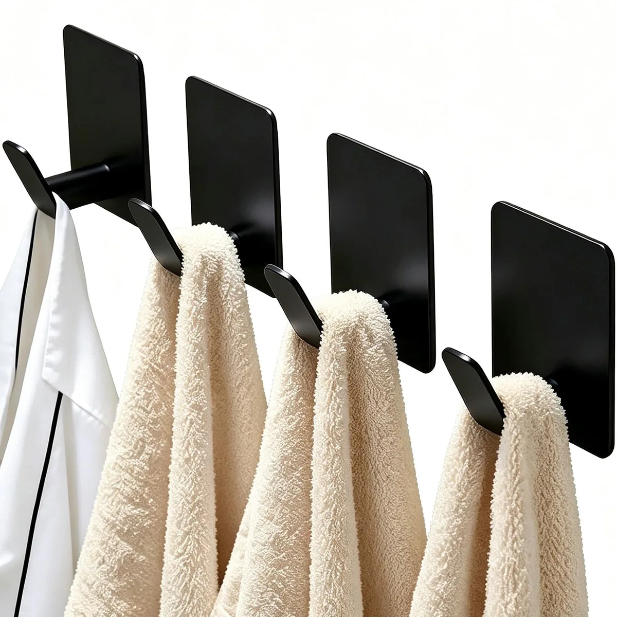 Four matte black stainless steel adhesive hooks with low-profile rectangular form