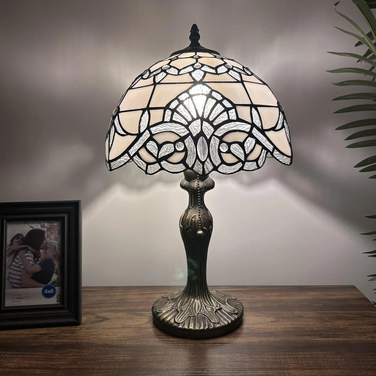 Tiffany style table lamp with white stained glass shade in lavender tones bronze zinc alloy base pull chain switch 12 inch wide 19