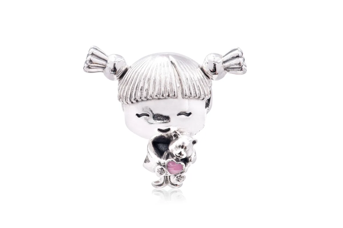 Sterling silver charm of a girl with pigtails holding a teddy bear with pink enamel heart