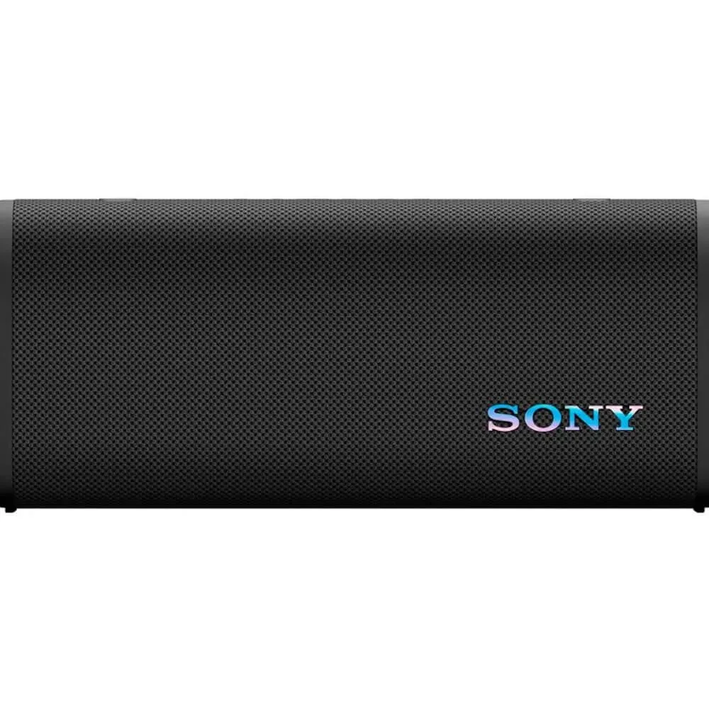 Black rectangular wireless speaker with fabric grille and attached shoulder strap
