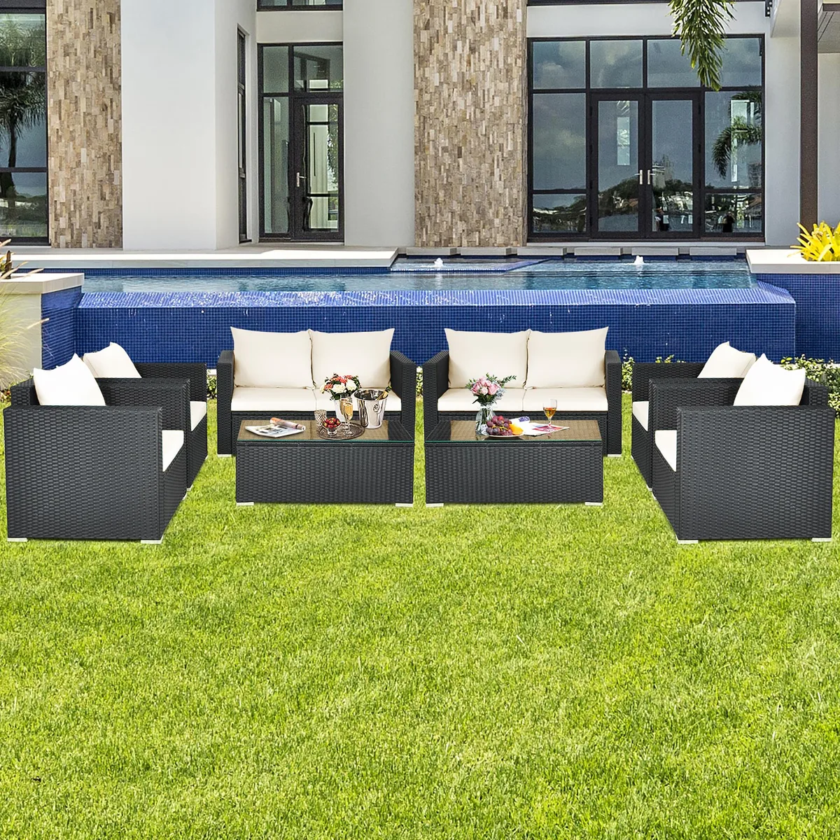 White rattan 8-piece patio sectional with glass-top coffee table and cushions