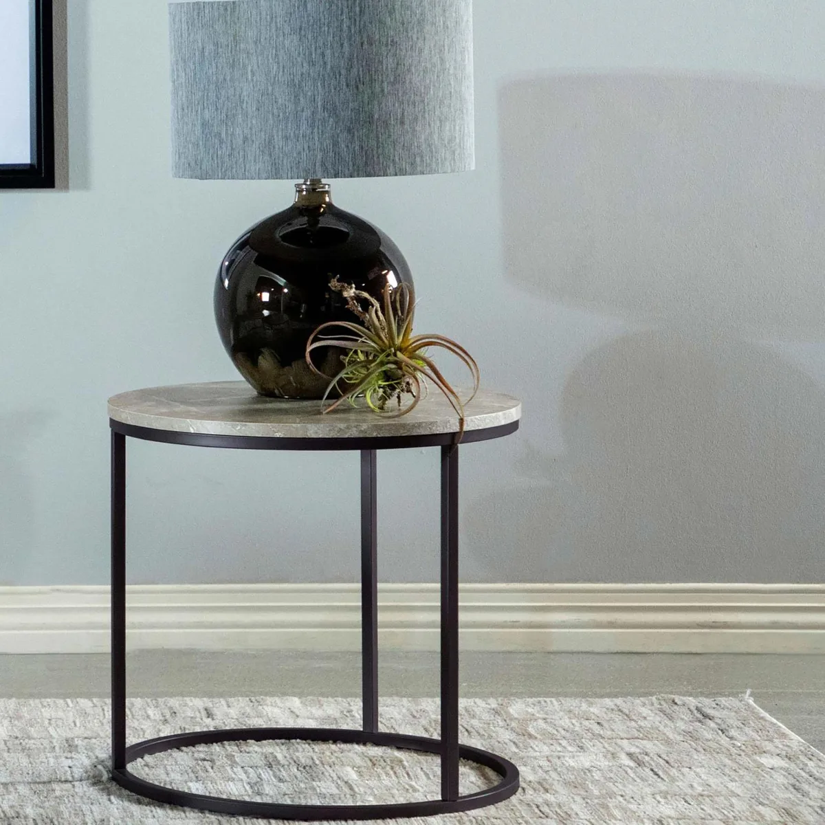 Grey faux marble top on slim gunmetal metal base