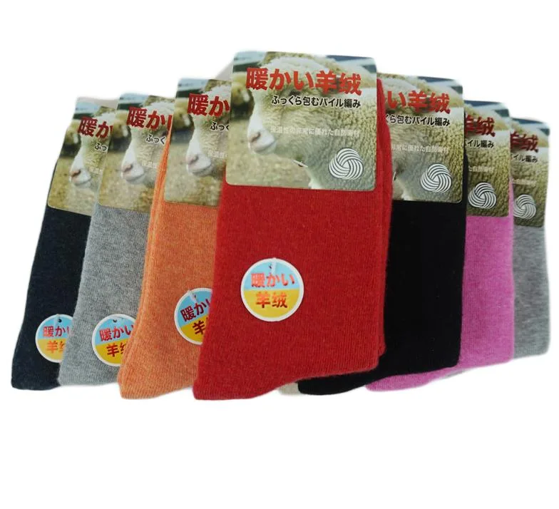 Red crew socks with a fluffy wool texture, folded flat showing ribbed cuffs and smooth toes