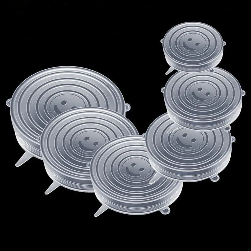Six white silicone stretch lids stacked in graduated round sizes